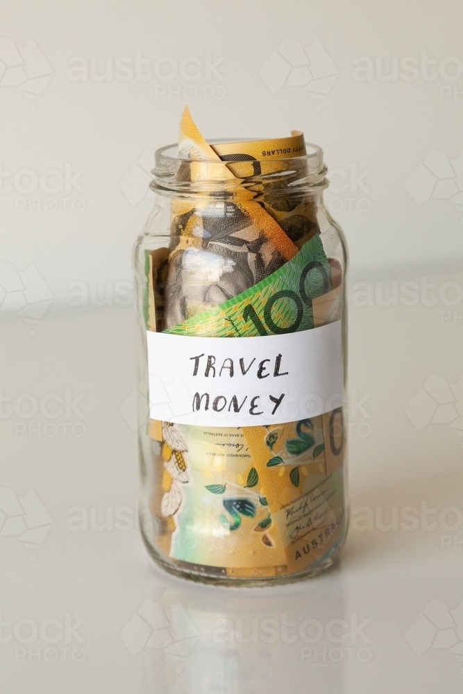 Image of Travel money jar full of australian notes for holiday trip