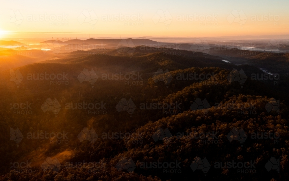 Tree-covered mountain landscape at sunset - Australian Stock Image
