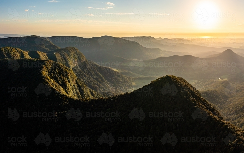 Tree-covered mountain landscape at sunset - Australian Stock Image