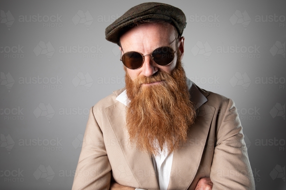 Trendy man with ginger beard and flat cap - Australian Stock Image