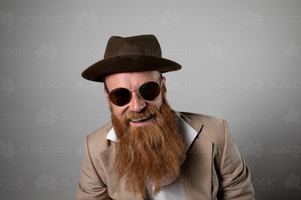 Trendy man with ginger beard, wearing felt hat - Australian Stock Image