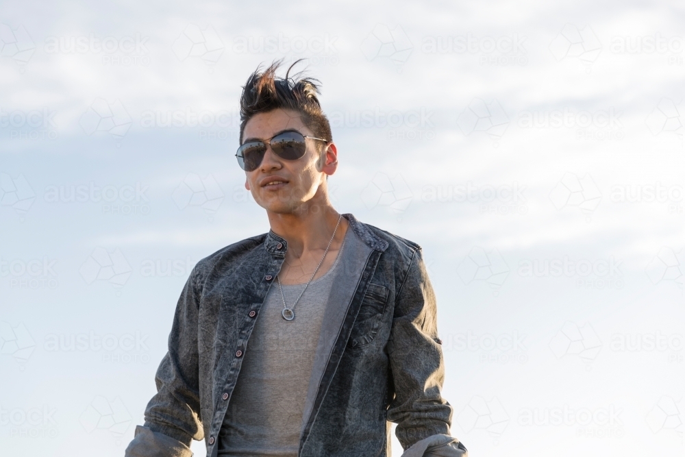 Trendy young man walking towards camera - Australian Stock Image