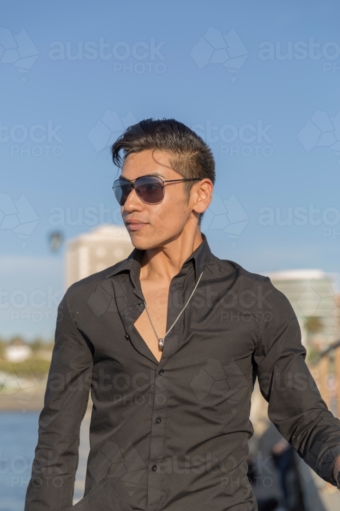 Trendy young man walking towards camera - Australian Stock Image