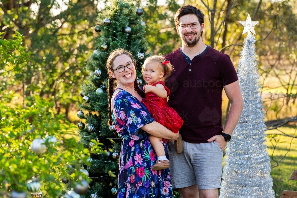 Triangle family of three laughing together at Christmas - Australian Stock Image