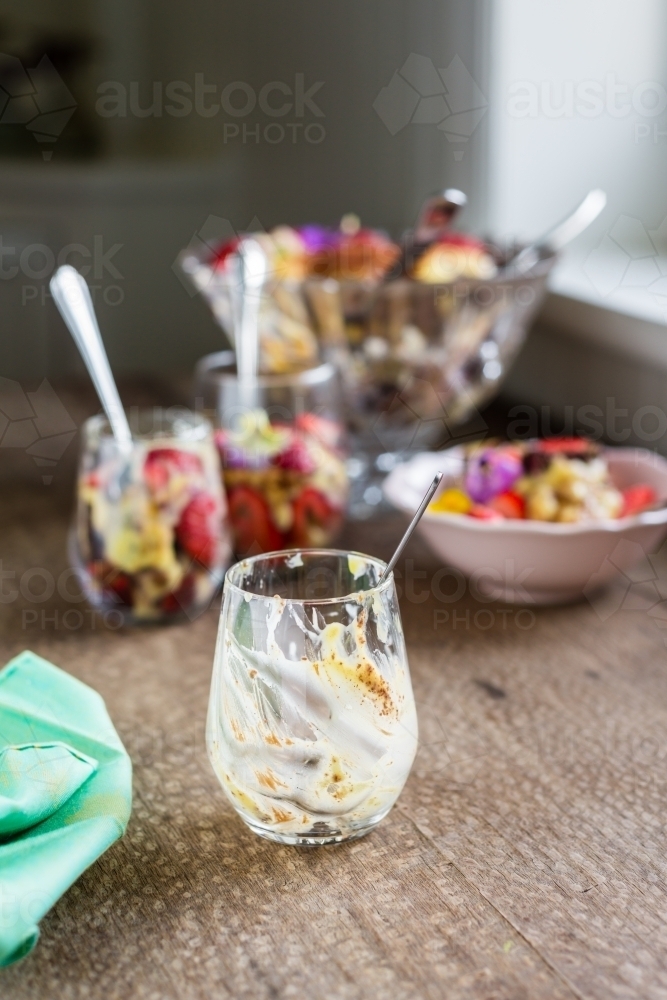 trifle dessert in a glass, empty glass with spoon - Australian Stock Image