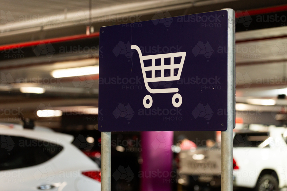 trolley return sign in undercover carpark at large shopping centre - Australian Stock Image