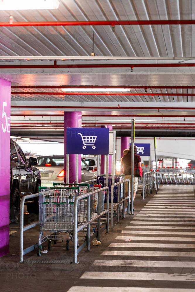 trolley return sign in undercover carpark at large shopping centre - Australian Stock Image