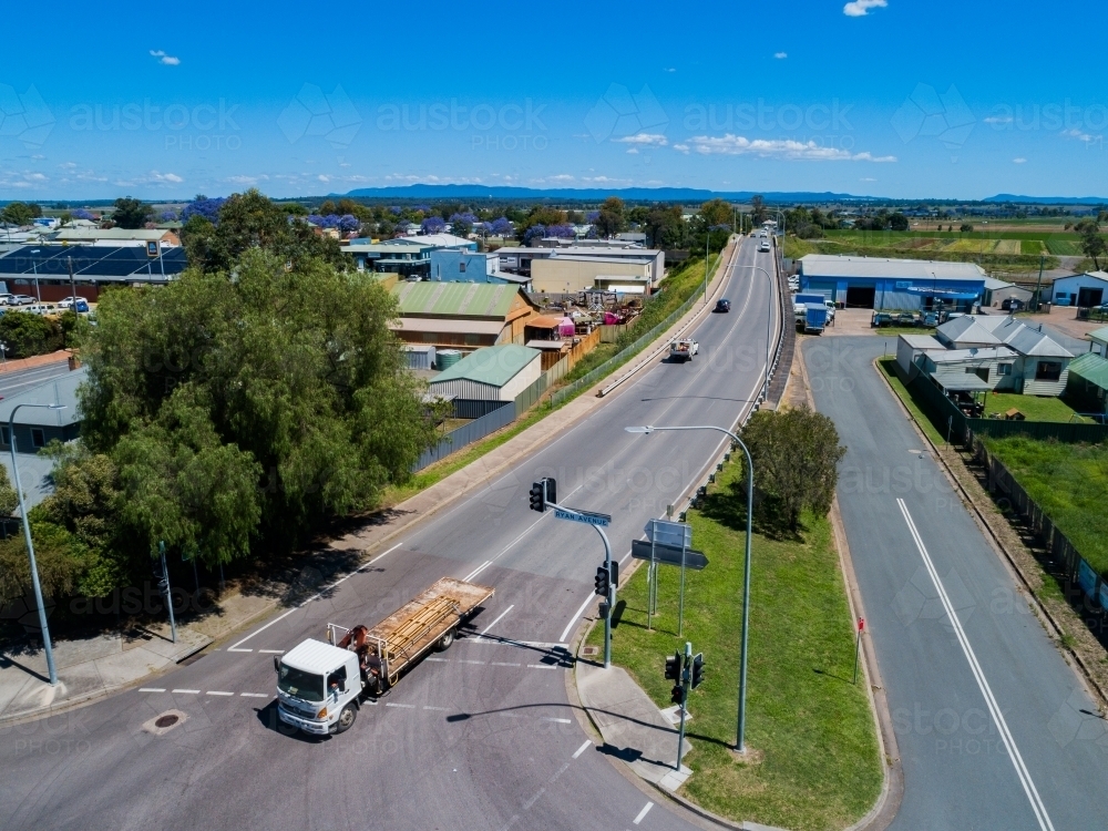 Truck coming through traffic lights to town on singleton - Australian Stock Image