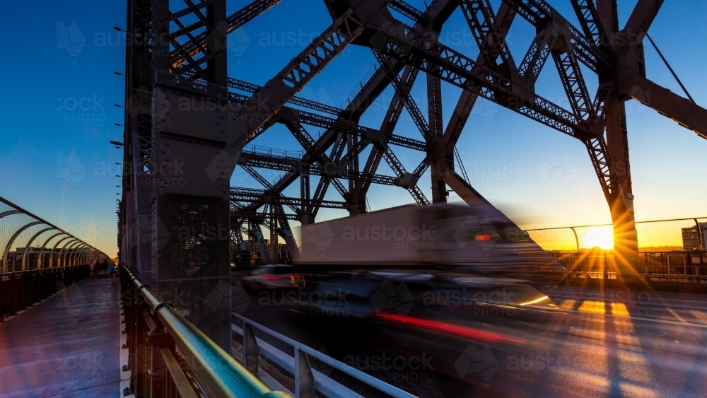 Truck motion blur on bridge with sun star in Brisbane CBD - Australian Stock Image