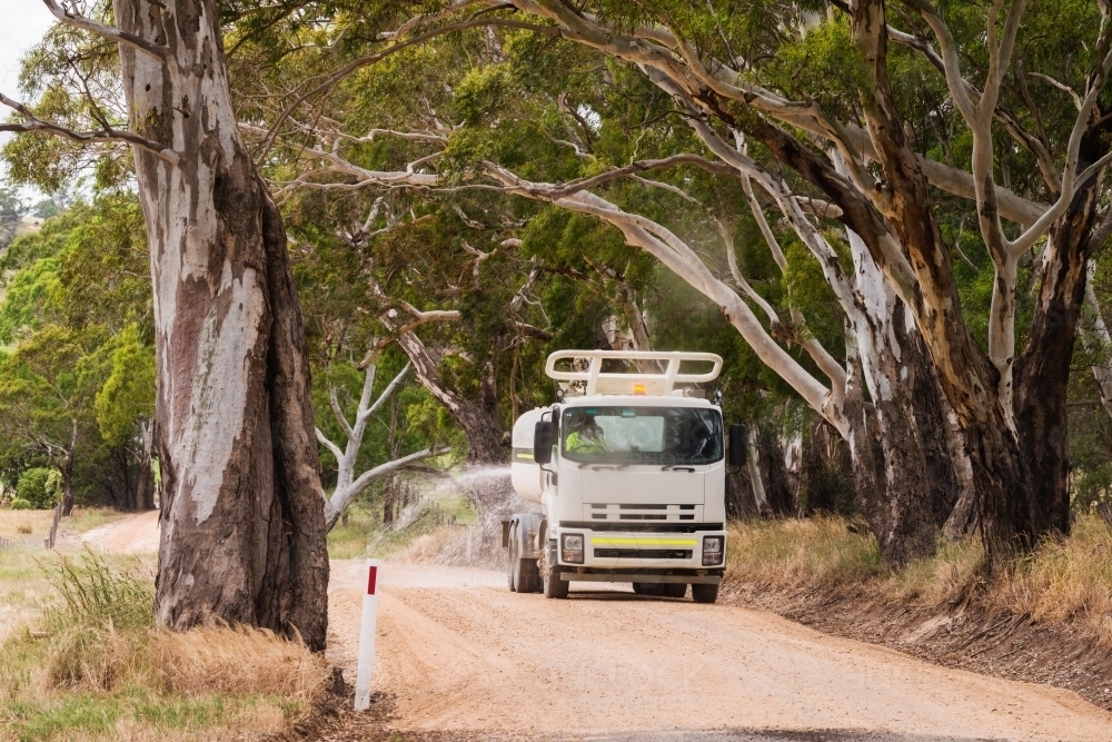 truck putting water on the road - Australian Stock Image