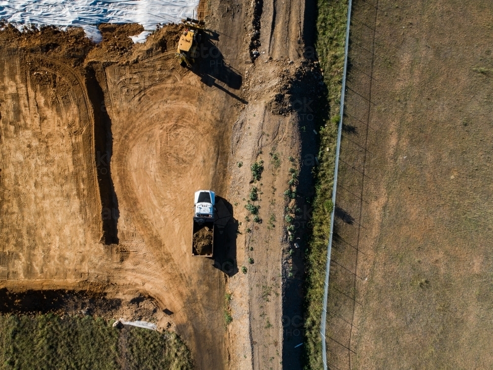 Image of Truck transporting load of dirt around worksite Austockphoto