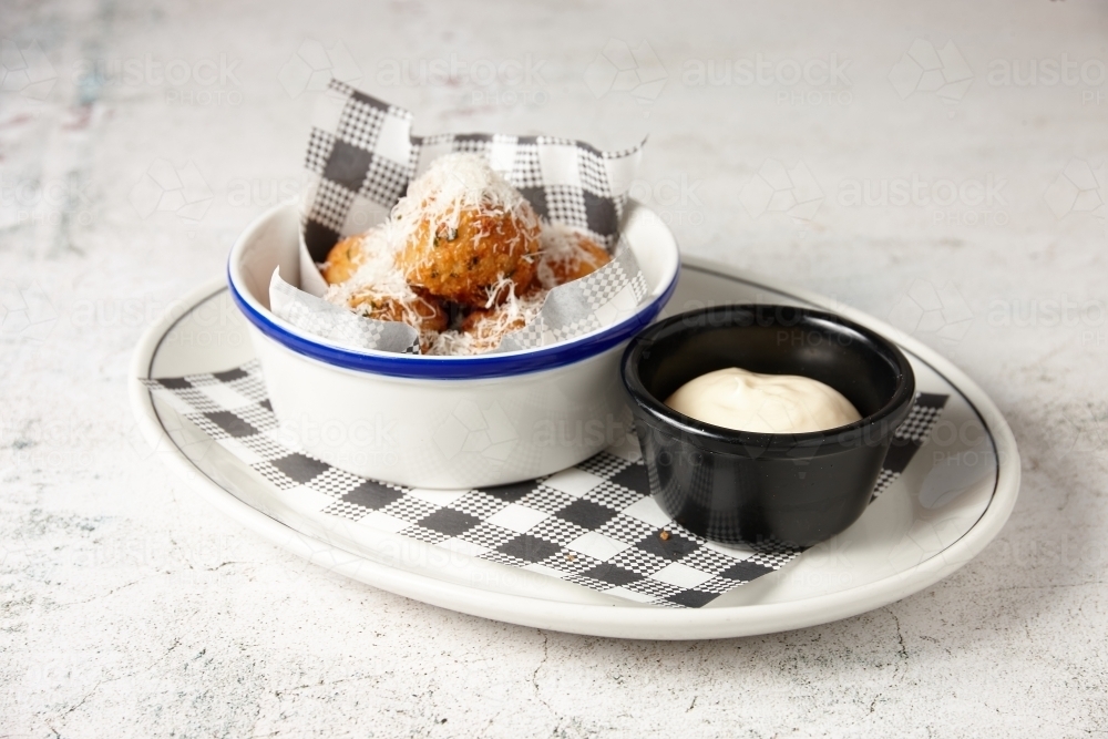 Truffle arancini balls on plate with mayonnaise - Australian Stock Image