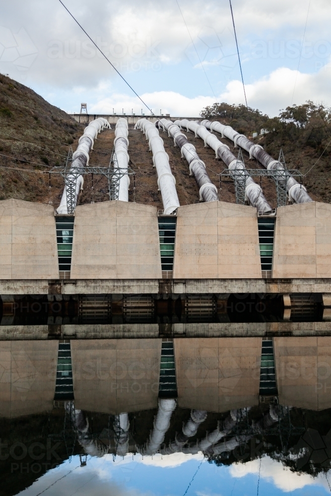 Tumut 3 power station reflected in water, part of the snowy hydro electric scheme - Australian Stock Image