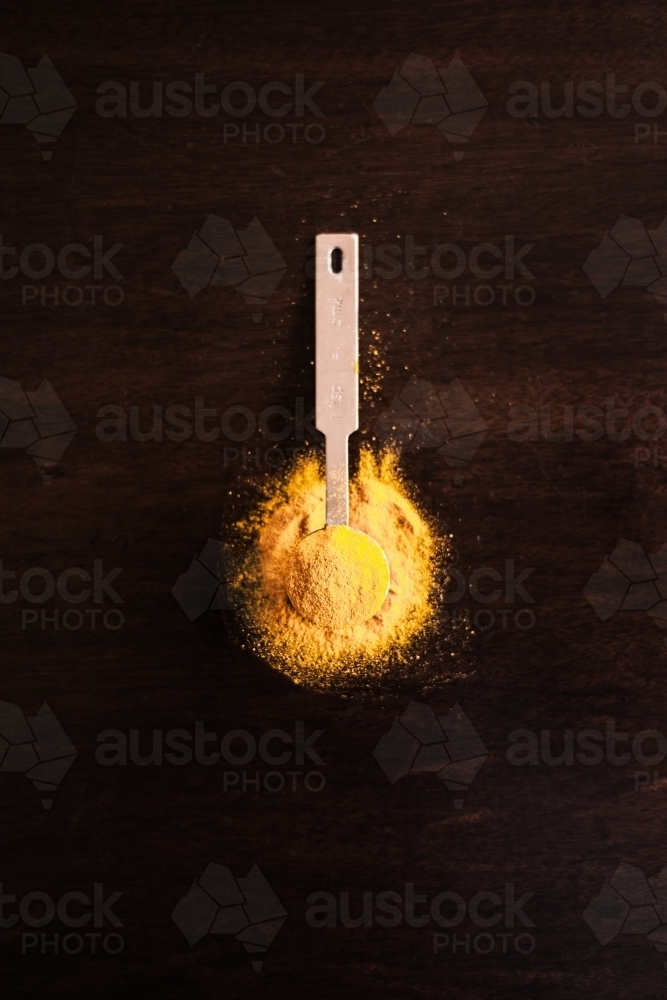 turmeric powder in a spoon - Australian Stock Image