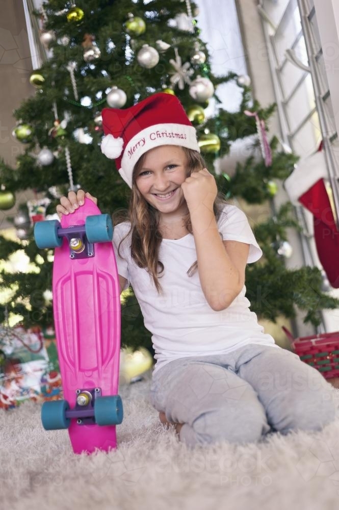 tween girl happy with her skateboard xmas gift - Australian Stock Image
