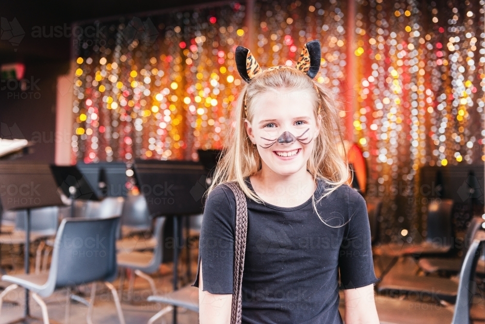 Tween girl in costume for a xmas concert at primary school, with bokeh background - Australian Stock Image