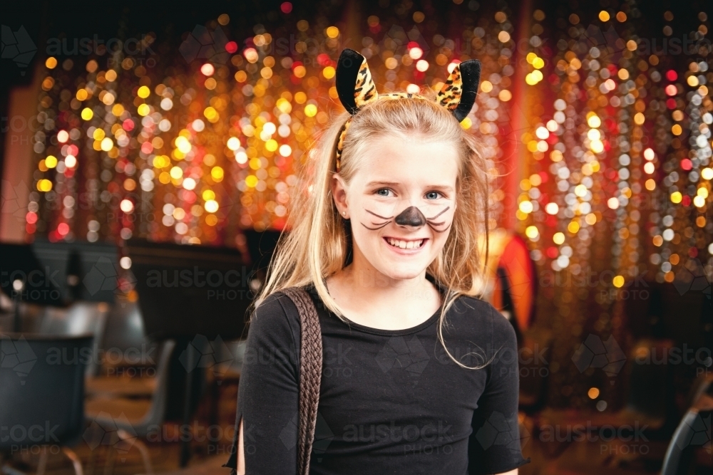 Tween girl in costume for a xmas concert at primary school, with bokeh background - Australian Stock Image