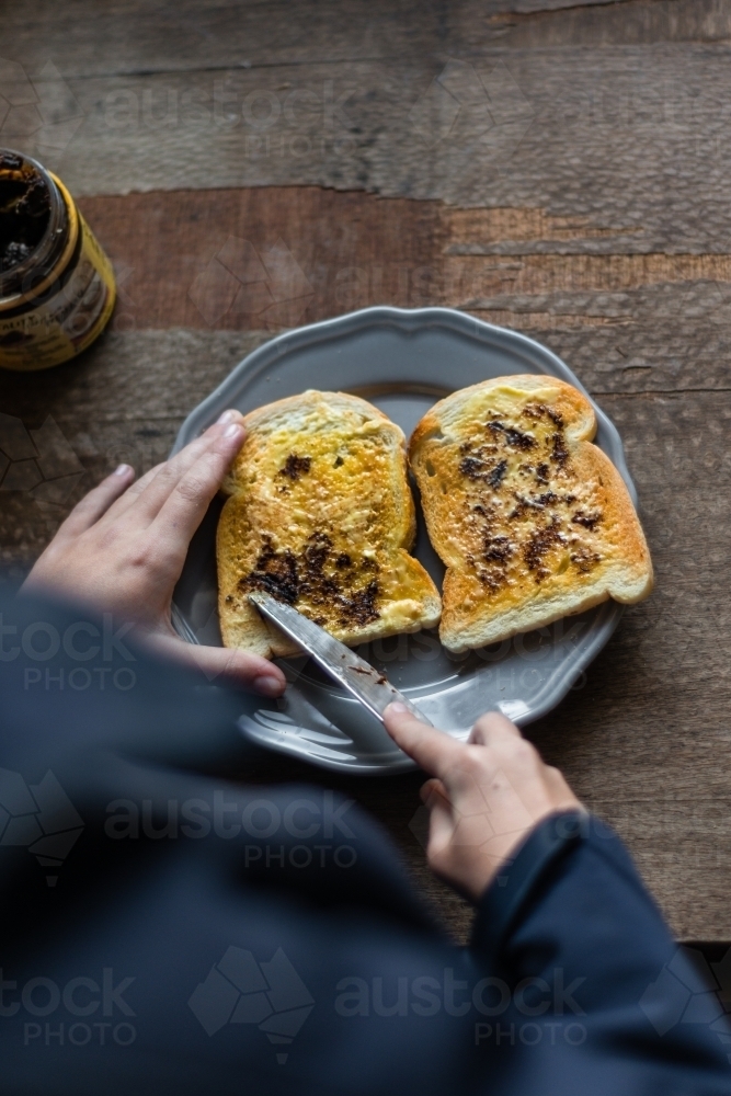 tween girl making toast in the morning - Australian Stock Image