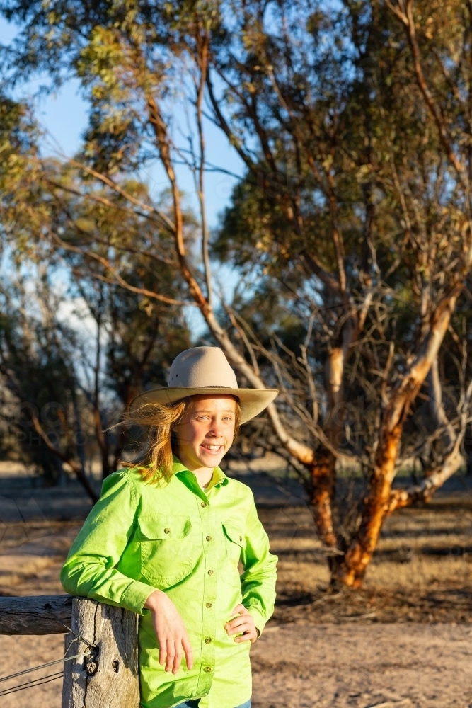 Tween girl on country property wearing akubra hat - Australian Stock Image