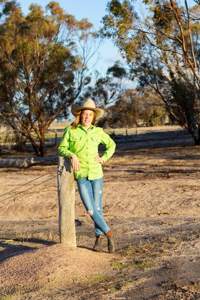 Tween girl on country property wearing akubra hat - Australian Stock Image