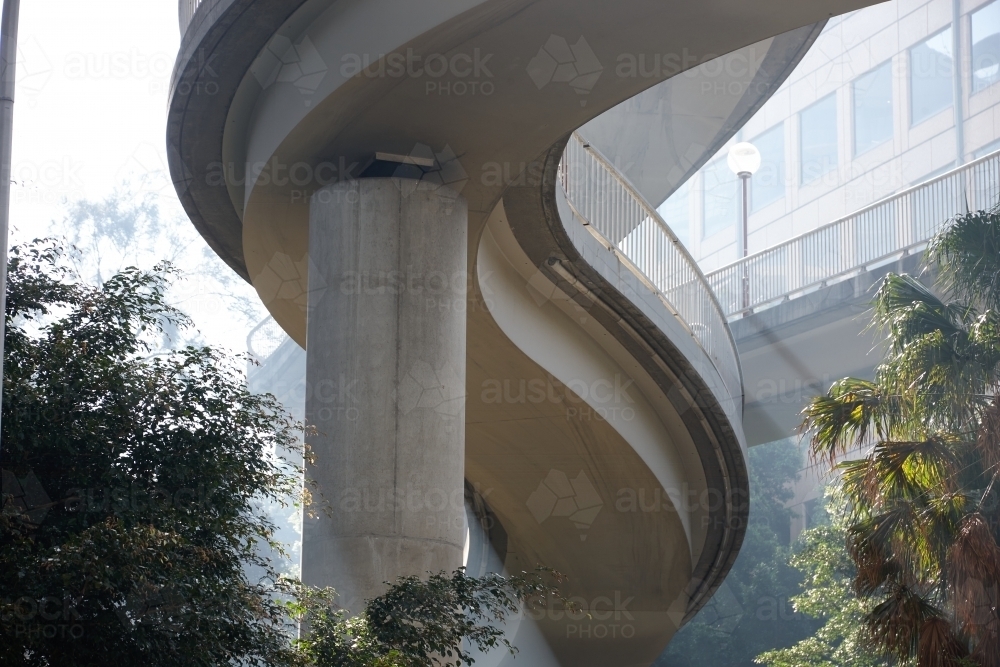 Image of Twisted ramp over trees in Sydney city - Austockphoto
