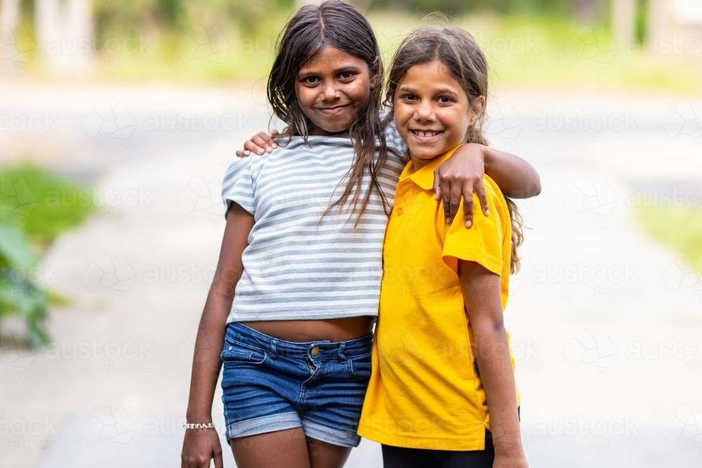 Image of two aboriginal children outside with arms around each other ...