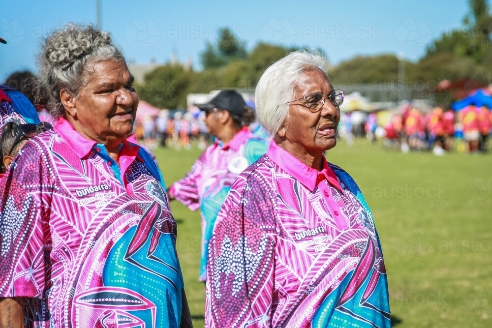 Two aboriginal women standing looking in the same direction - Australian Stock Image