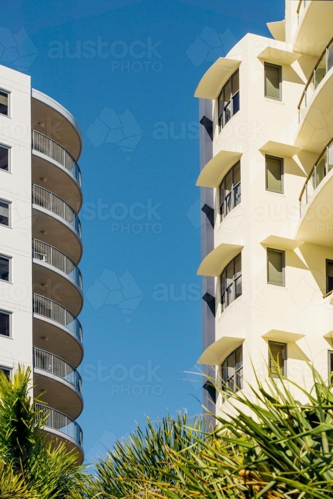 Two apartment blocks facing one another against a blue sky - Australian Stock Image