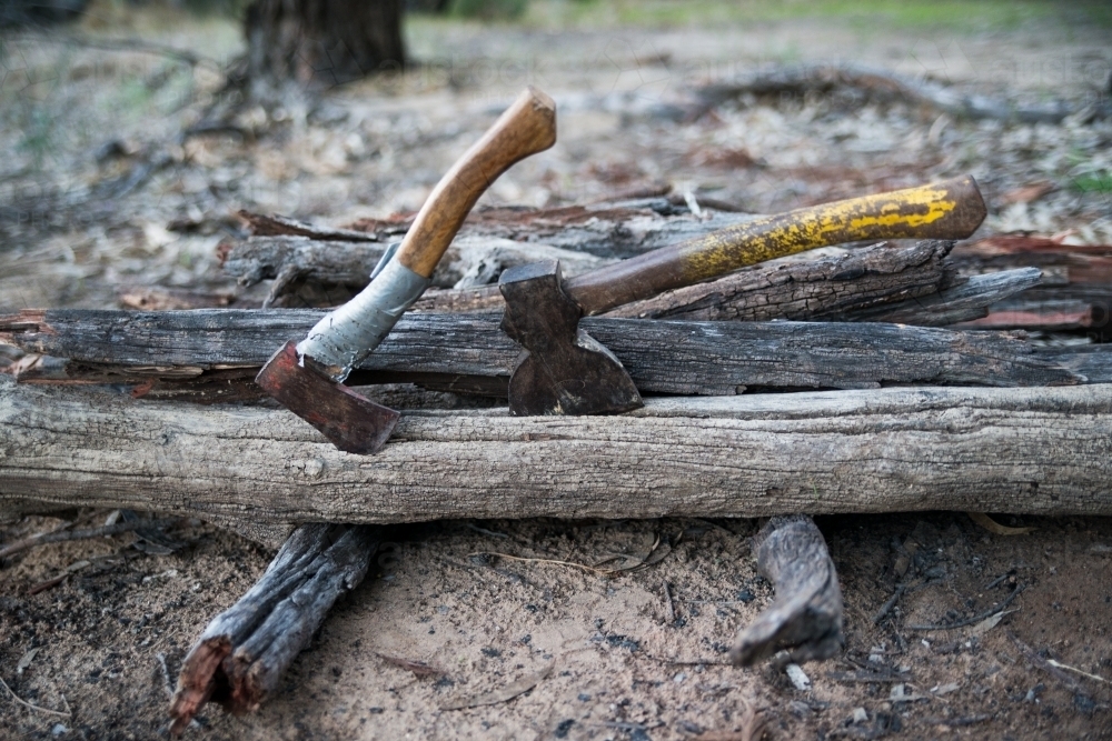 Two axes in wood pile - Australian Stock Image
