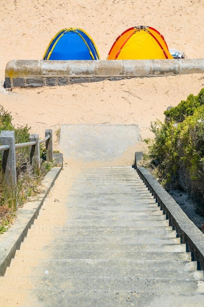 Two beach tents at the bottom of steps leading to the beach - Australian Stock Image