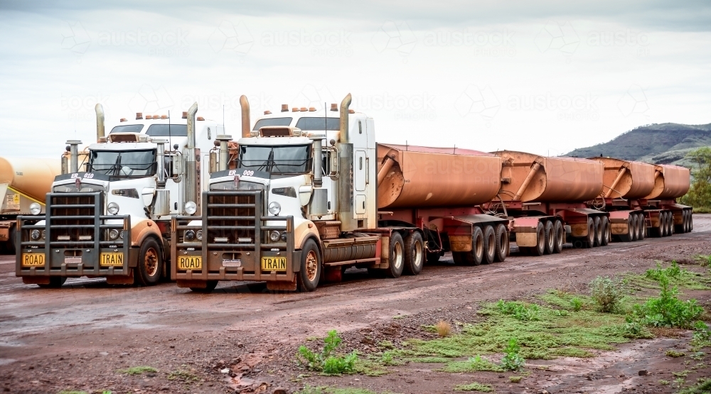 Two big road train trucks side by side on outback road - Australian Stock Image