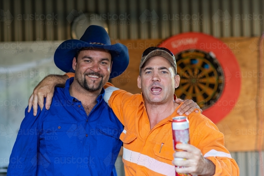 two blokes in their man cave having a beer - Australian Stock Image
