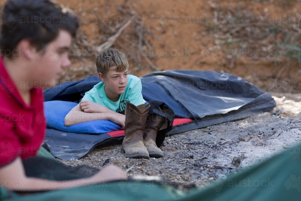 Two boys camping out in swags - Australian Stock Image