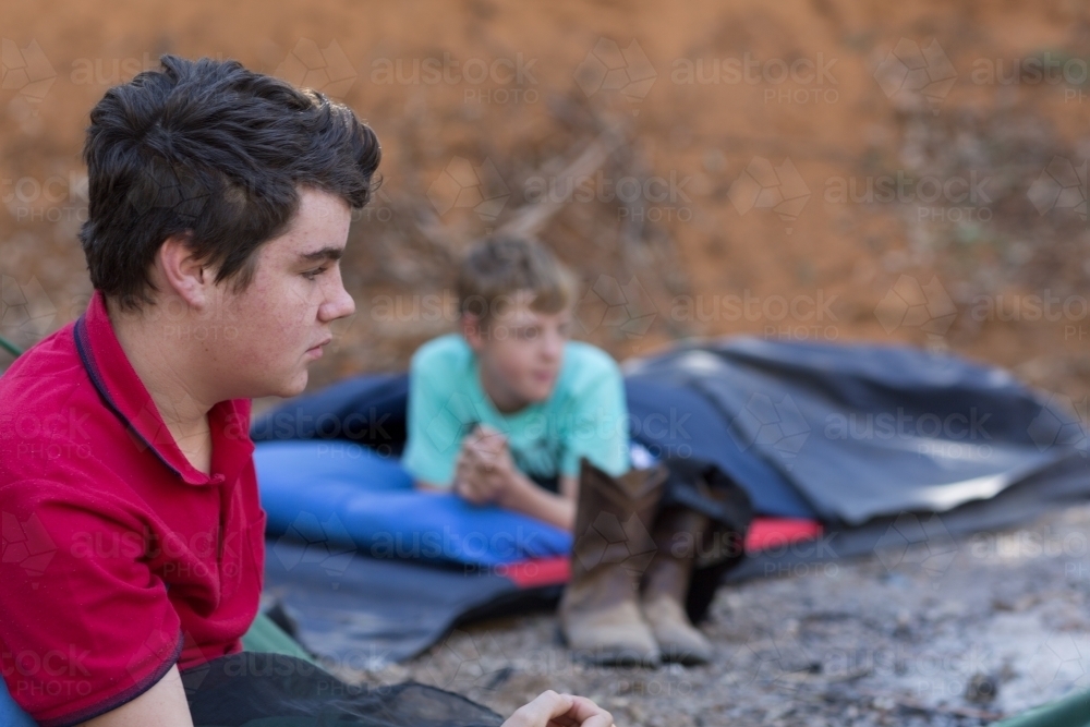Two boys in swags camping out - Australian Stock Image