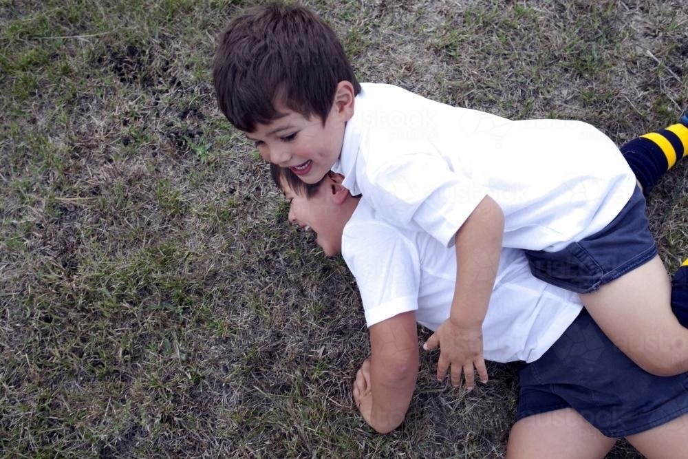 Two boys tackling during a football game - Australian Stock Image