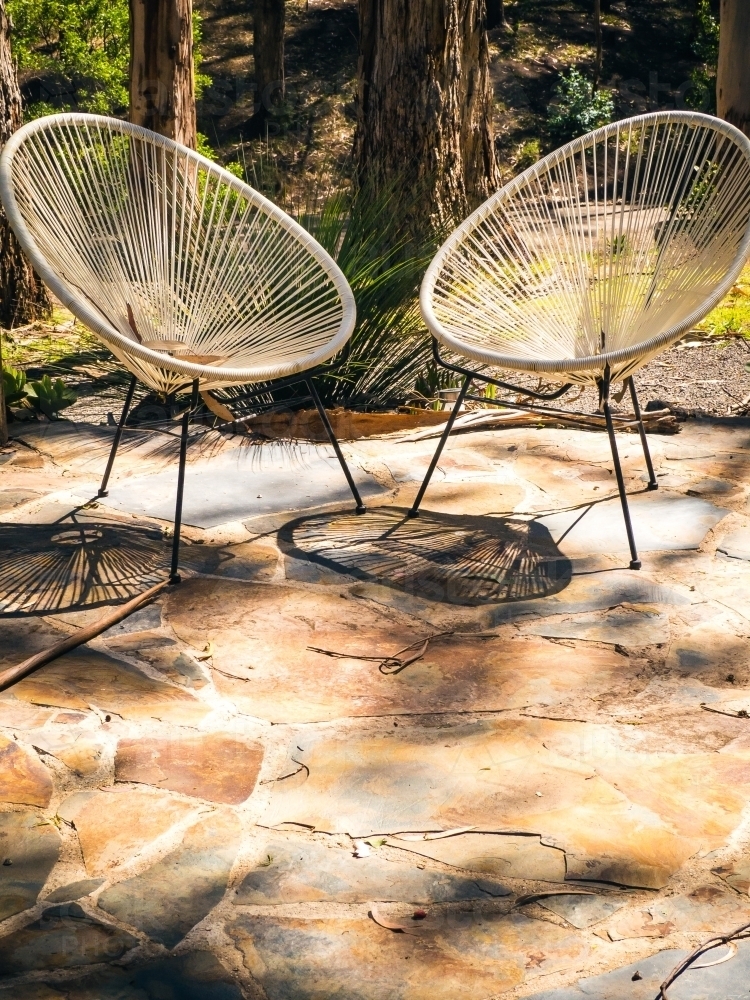 Two chairs in the afternoon sun on a patio - Australian Stock Image