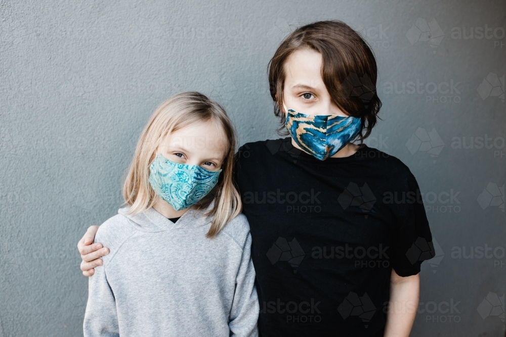 two children wearing fabric masks during the corona COVID-19 pandemic, masks are now compulsory. - Australian Stock Image