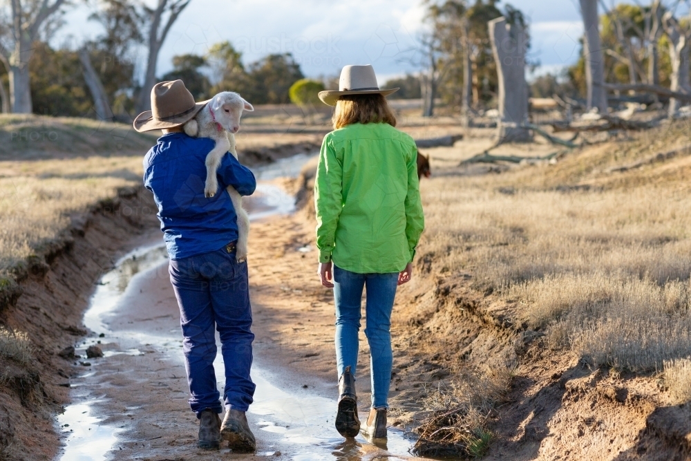 Two country kids walking along a creek - Australian Stock Image
