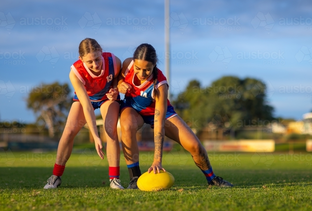 two female footballers going for the ball during training - Australian Stock Image
