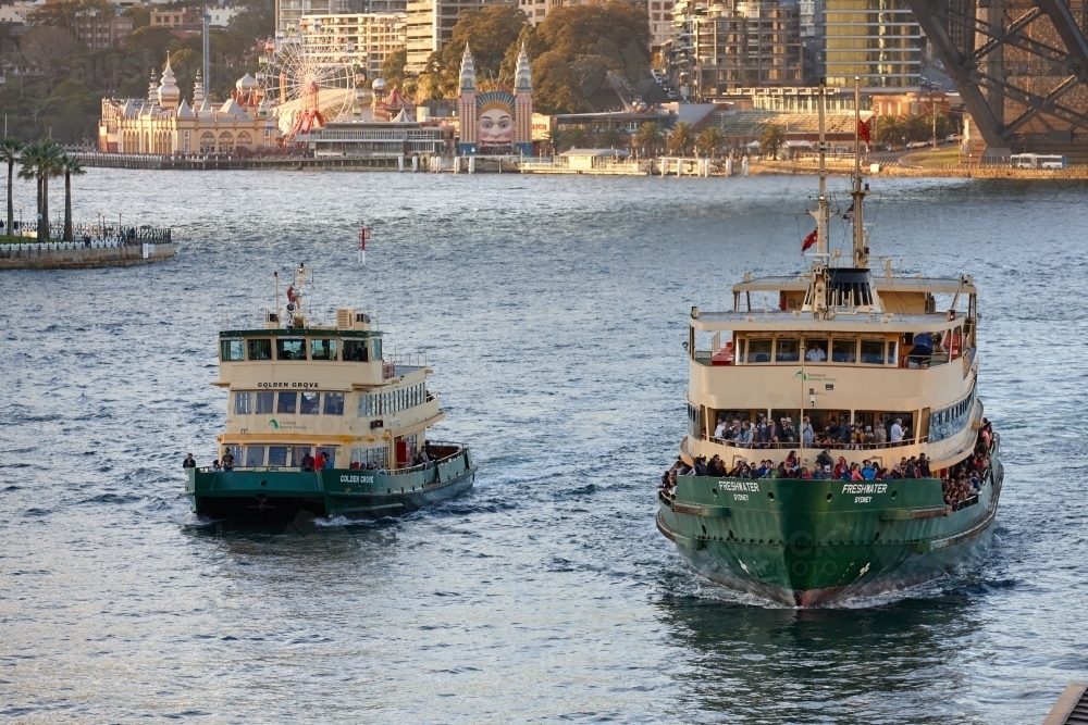 Two ferries crossing the water besides the Harbour Bridge - Australian Stock Image