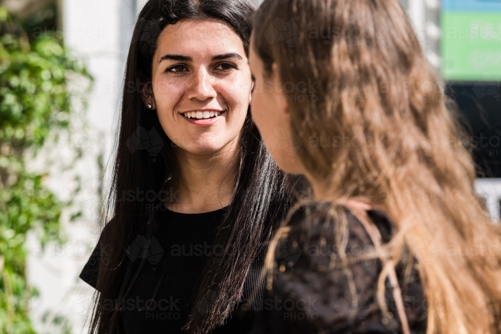 two friends chatting outdoors - Australian Stock Image
