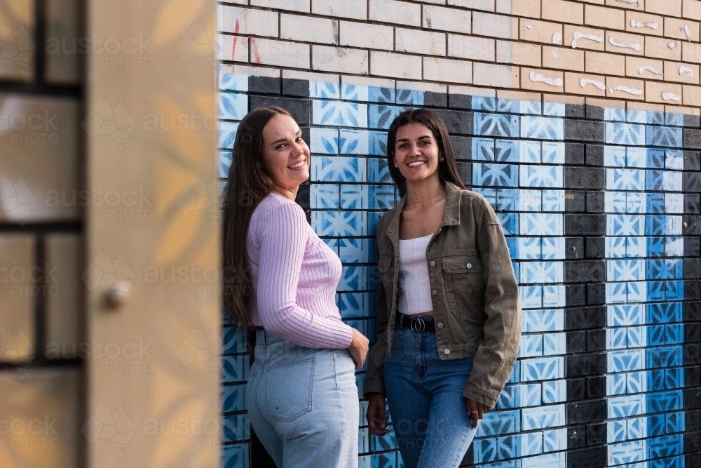 two friends hanging out in an urban setting - Australian Stock Image