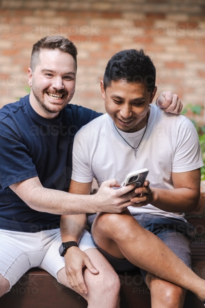 two gay men sitting outdoors - Australian Stock Image