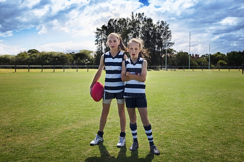 Two girl team players in AFL football - Australian Stock Image