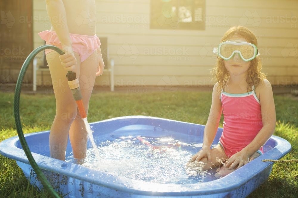Two girls playing in a wading pool - Australian Stock Image