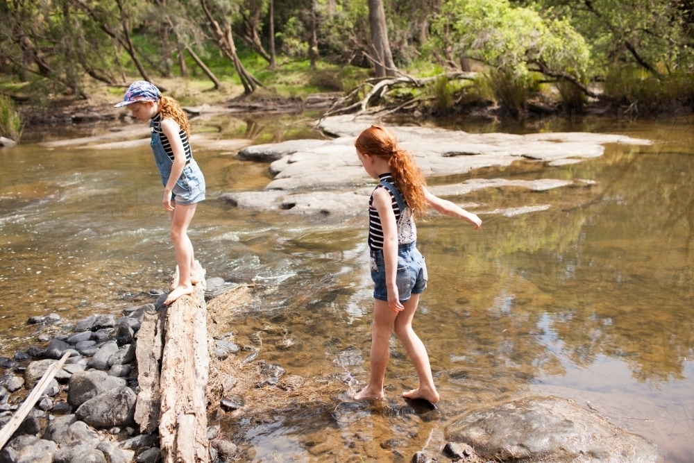 Two girls playing in the river - Australian Stock Image