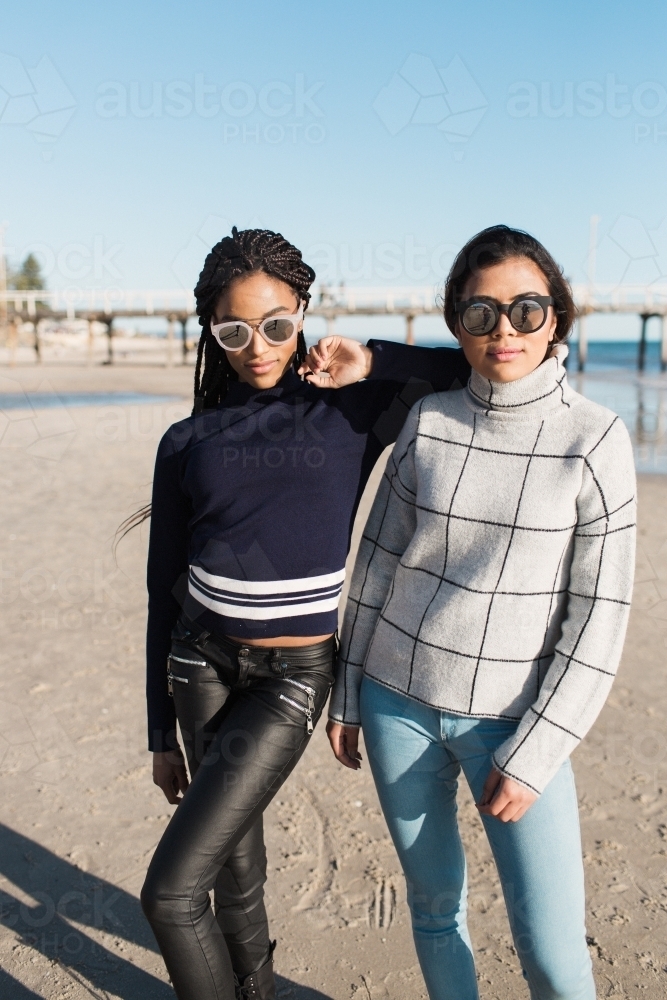 Two girls posing on a beach - Australian Stock Image