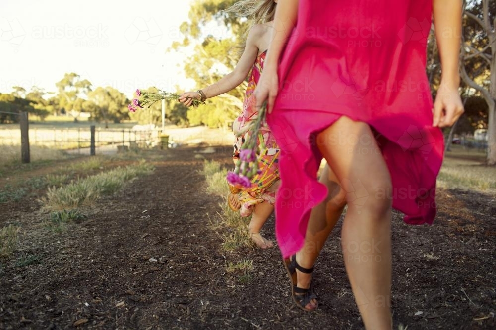 Two girls running in a park - Australian Stock Image