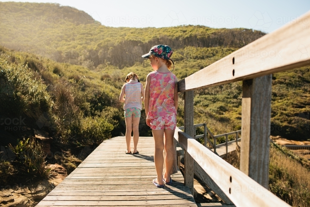 Two girls standing on a boardwalk - Australian Stock Image