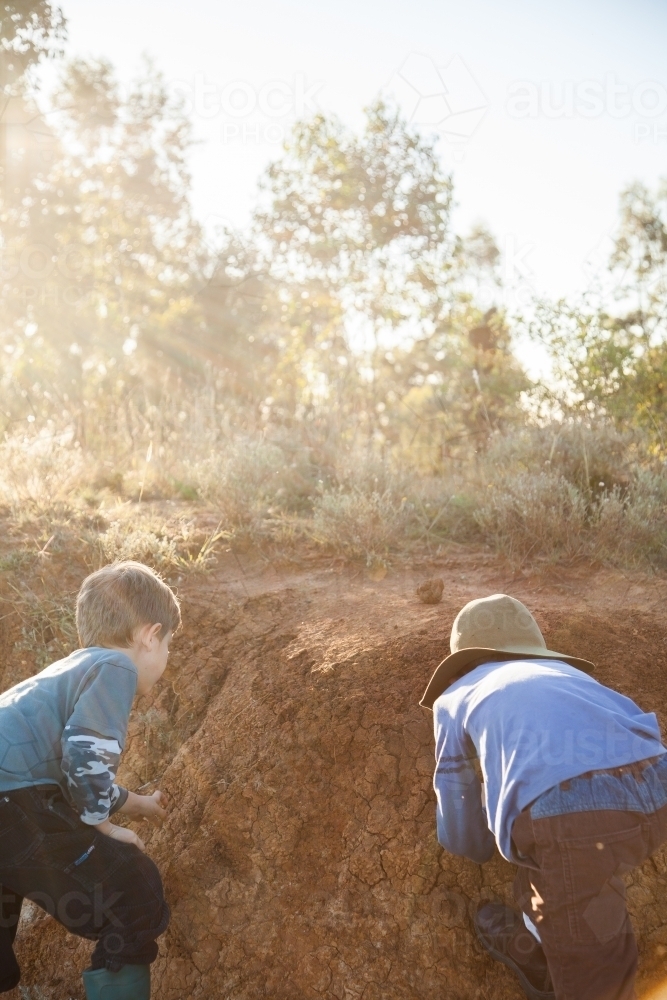 Image of Two happy boys playing in the dirt outside - Austockphoto